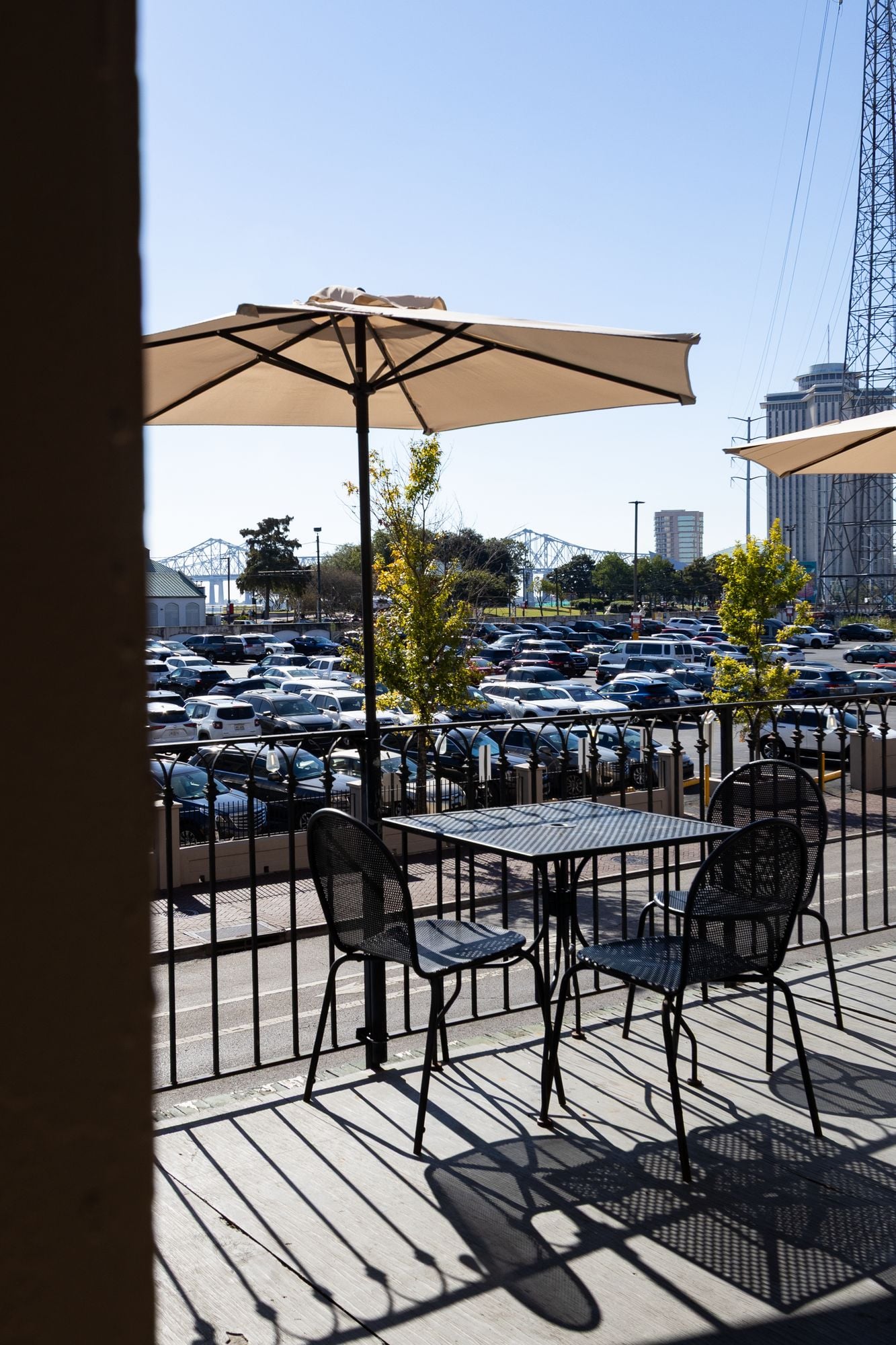 Bistro table under a canvas umbrella on the wrought-iron balcony