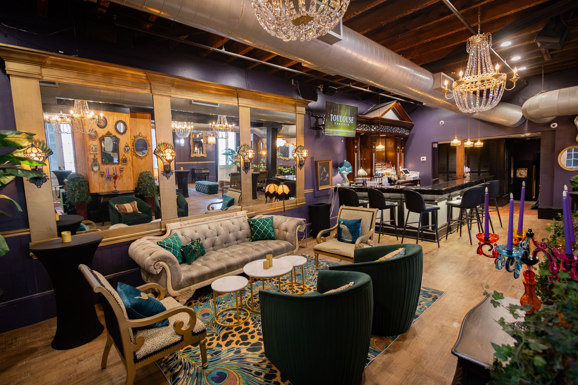 Lounge set for an event with candles and florals beside the bar