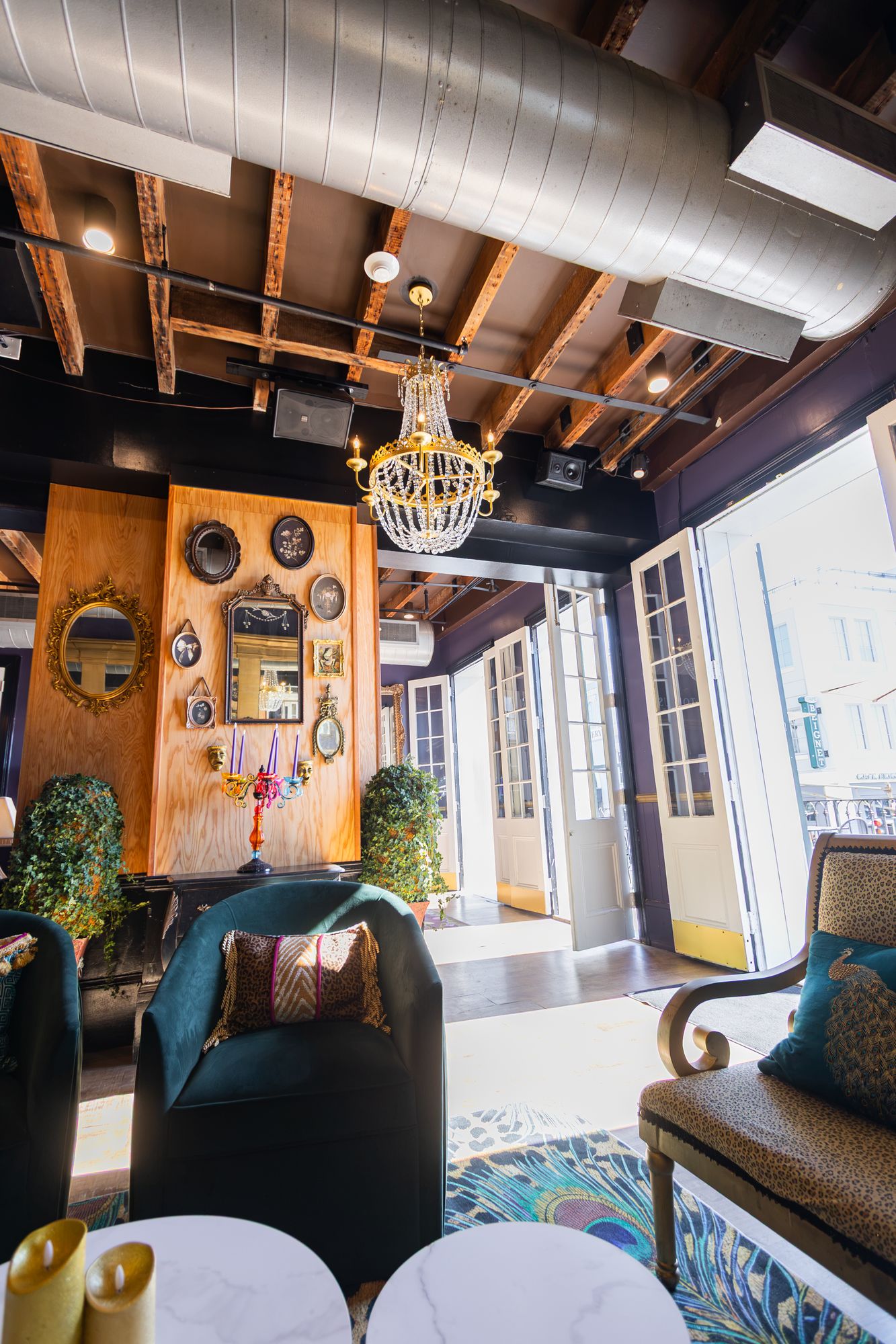 Velvet armchairs beside open French doors to the balcony